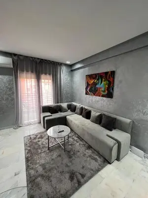 a living room with a couch and a table at Superbe appartement T2 plein centre de Marrakech in Marrakech