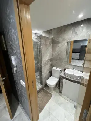 a bathroom with a toilet and a sink at Superbe appartement T2 plein centre de Marrakech in Marrakech