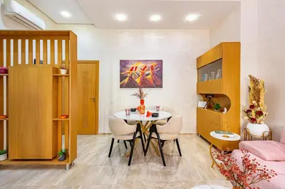 a living room with a table and chairs in a room at Stylish Cozy Appartement in marrakech with Pool in Marrakech