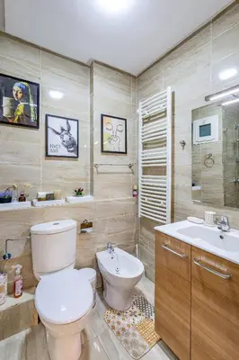 a bathroom with a toilet and a sink at Stylish Cozy Appartement in marrakech with Pool in Marrakech