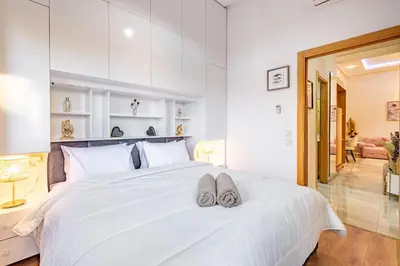 a bedroom with a white bed with two slippers on it at Stylish Cozy Appartement in marrakech with Pool in Marrakech