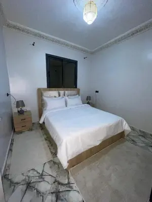 a bedroom with a large white bed and a lamp at Marrakech Oasis Retreat in Marrakech
