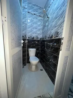 a bathroom with a toilet and a glass shower at Marrakech Oasis Retreat in Marrakech