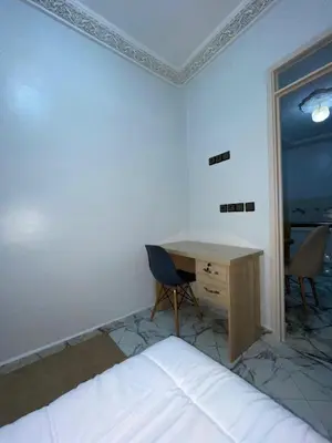 a bedroom with a desk and a bed and a table at Marrakech Oasis Retreat in Marrakech