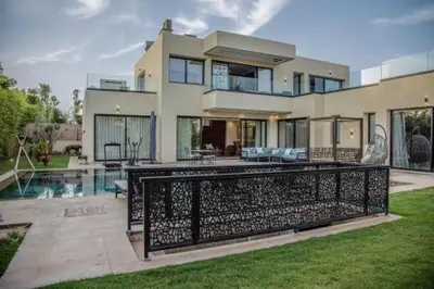 a large house with a fence in front of it at Villa Athena 4 chambres piscine privée et jaccuzi in Marrakech