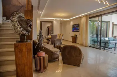 a living room with a lion head on the wall at Villa Athena 4 chambres piscine privée et jaccuzi in Marrakech
