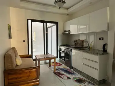 a kitchen with a couch and a stove top oven at appartement Lamrani in Marrakech