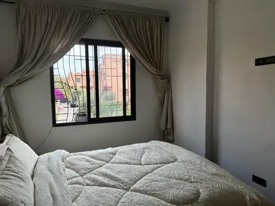 a bedroom with a bed and a window at appartement Lamrani in Marrakech