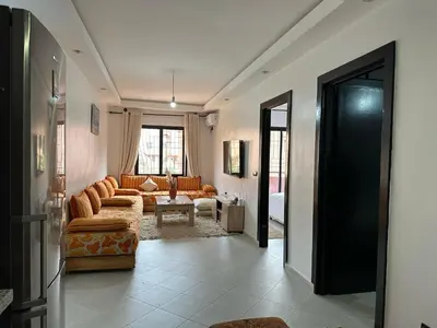 a living room with a couch and a table at appartement Meryam in Marrakech