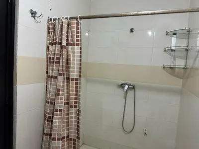 a shower with a shower curtain in a bathroom at appartement Meryam in Marrakech