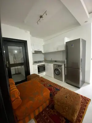 a kitchen with a couch and a refrigerator at appartement Meryam in Marrakech