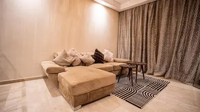 a living room with a couch and a table at Grand T2, terrasse au coeur de Gueliz in Marrakech