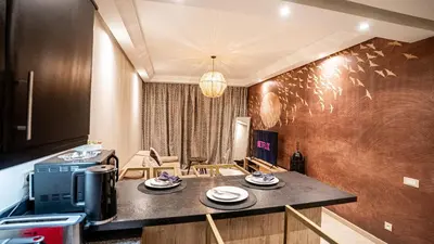 a kitchen with a counter with plates on it at Grand T2, terrasse au coeur de Gueliz in Marrakech