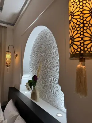 a bedroom with a mirror and a vase with a flower at Traditional Moroccan Flat in Palmeraie in Marrakech