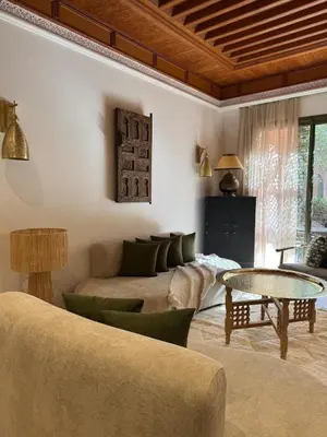a living room with a couch and a table at Traditional Moroccan Flat in Palmeraie in Marrakech