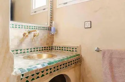 a bathroom with a sink and a mirror at Riad Amani in Marrakech