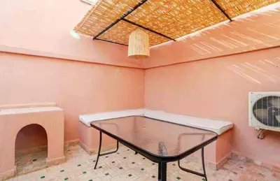 a small room with a table and a heater at Riad Amani in Marrakech