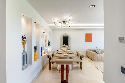 a living room with a table and a couch at Luxury Saphir- Golf, piscines & calme in Marrakech