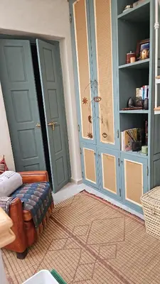 a room with two doors and a couch in a room at Séjour au cœur de la medina in Marrakech
