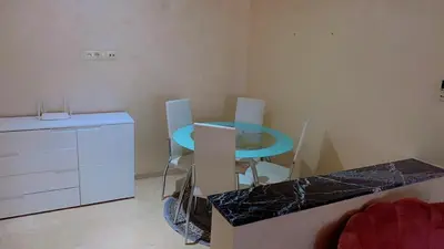 a kitchen with a blue table and two chairs at Hivernage Cosy in Marrakech