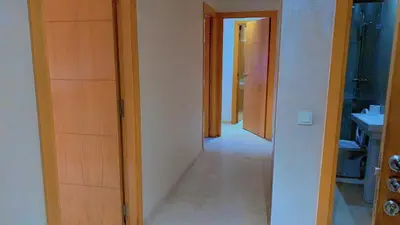 a hallway of a bathroom with a sink and a mirror at Hivernage Cosy in Marrakech