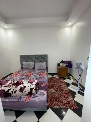 a bedroom with a bed with a cow blanket at Mini Studio in Marrakech