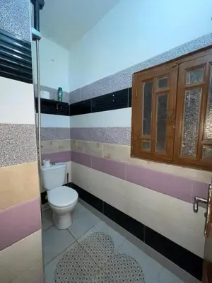 a bathroom with a toilet and a glass shower at Mini Studio in Marrakech
