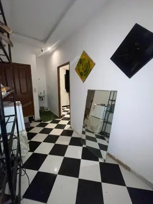 a room with a black and white checkered floor at Mini Studio in Marrakech