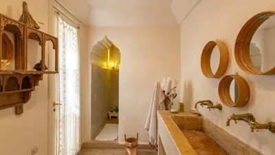 a bathroom with a tub and a sink and mirrors at Dar Z5 3 bedrooms in Marrakech