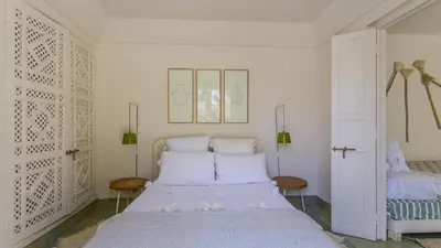 a white bedroom with a bed and two chairs at Dar Z5 3 bedrooms in Marrakech