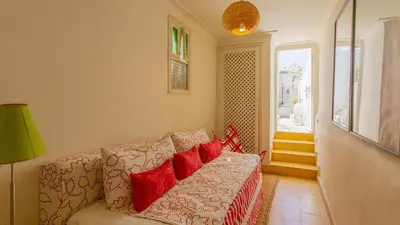 a living room with a couch with red pillows at Dar Z5 3 bedrooms in Marrakech