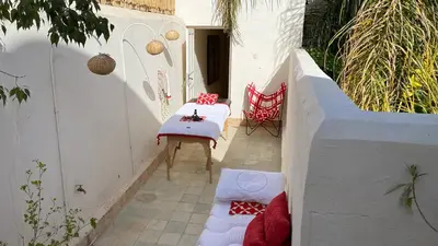 a small patio with a table and a chair at Dar Z5 3 bedrooms in Marrakech