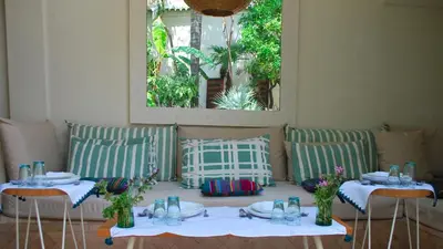 two tables and chairs with plates and glasses on them at Dar Z5 3 bedrooms in Marrakech