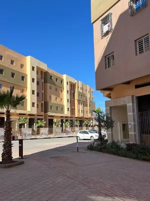 a car is parked in front of some buildings at Appartement Marrakech in Marrakech