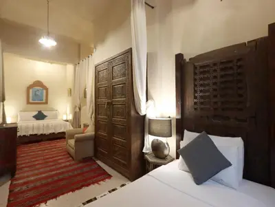 a bedroom with a bed and a couch and a bed and a room at Riad Villa Elgada in Marrakech