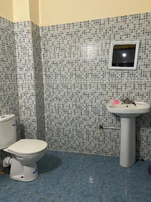 a bathroom with a toilet and a sink at Aéroport, Appartement in Marrakech