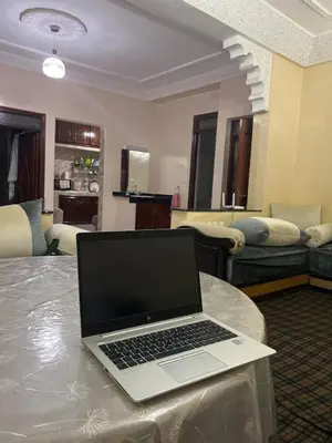 a laptop computer sitting on a table in a living room at Aéroport, Appartement in Marrakech