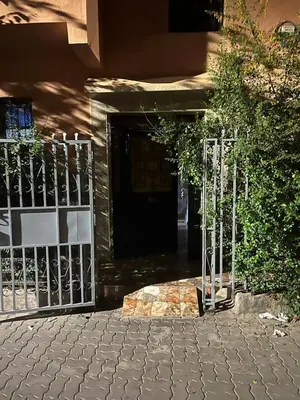 a gate in front of a building with a door at Aéroport, Appartement in Marrakech