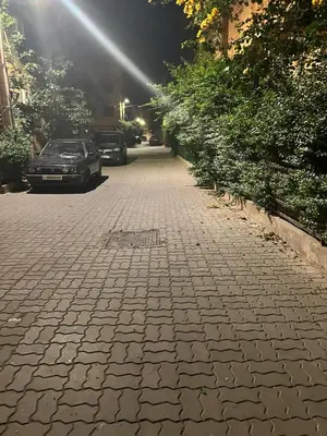 a cobblestone street with cars parked on it at Aéroport, Appartement in Marrakech