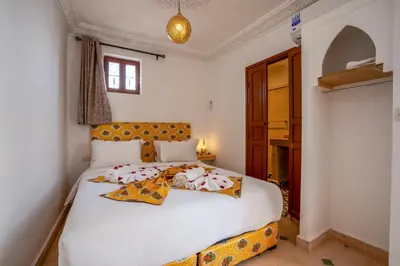 a bedroom with a bed with two dolls on it at Riad Ilyan & Spa in Marrakech