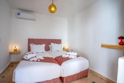 a bedroom with a bed with stuffed animals on it at Riad Ilyan & Spa in Marrakech