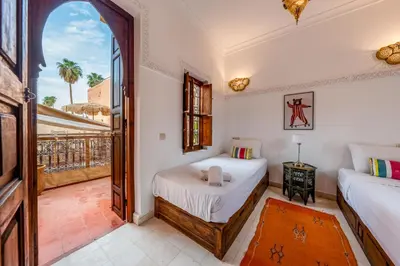 a bedroom with two beds and a window at L'Alchimiste - Riad Entier à 10 minutes Jemaa El Fna in Marrakech