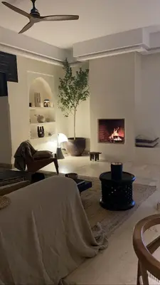 a living room with a fireplace and a bed at Marrakech Apartment with garden Marrakech in Marrakech