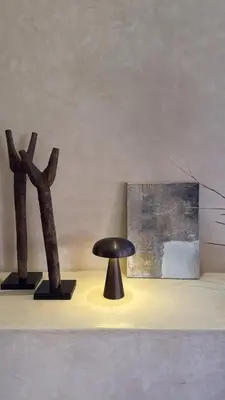 a black stool sitting on a table next to a painting at Marrakech Apartment with garden Marrakech in Marrakech