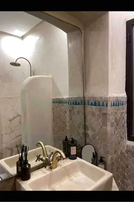 a bathroom with a sink and a mirror at Marrakech Apartment with garden Marrakech in Marrakech