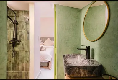 a bathroom with a sink and a shower and a mirror at Maison 3 chambre avec bassin chauffée centre ville Gueliz in Marrakech