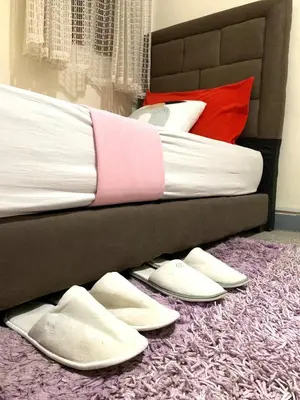 a bed with white shoes on the floor next to a bed at Steps from Airport only 5 minutes ,Ideal for Travelers in Marrakech