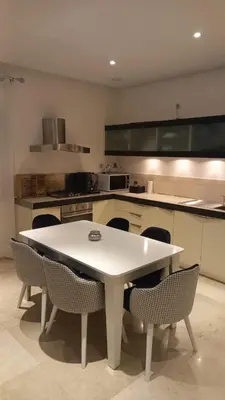 a kitchen with a white table and chairs at Appartement centre Marrakech in Marrakech