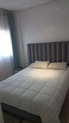 a bedroom with a large white bed with a window at Appartement centre Marrakech in Marrakech