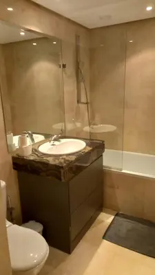a bathroom with a sink and a shower and a toilet at Appartement centre Marrakech in Marrakech